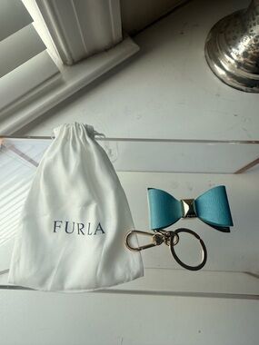 Title: Furla Textured Leather Bow Keychain Bag Charm - Teal/GoldDescription